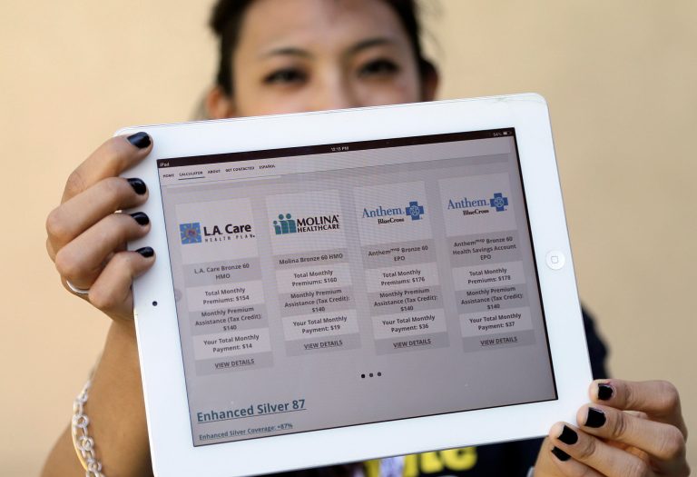 FILE - In this Oct. 1, 2013, file photo, Campus coordinator Natasha Buranasombati of the California State University Health Insurance Project poses with a tablet showing an application that will figure health options for, in this case, an 18-year-old individual with an $18,000 income and living in the Los Angeles area, on the campus of CSU-Los Angeles. Officials with California's health insurance exchange said Tuesday, Jan. 21, 2014, that about 625,000 people have signed up for an individual or family policy under the federal health care reforms, but enrollments for Latinos and younger people continue to lag expectations. (AP Photo/Reed Saxon, File)