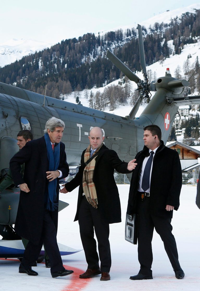 U.S. Secretary of State John Kerry, front left, arrives in Davos, Switzerland,  Thursday Jan. 23, 2014, where he will attend the World Economic Forum annual meeting.  The UN-backed international conference on the Syrian crisis will continue with separate talks between the rival delegations in Geneva, Switzerland, on upcoming Friday. (AP Photo / Gary Cameron, pool)