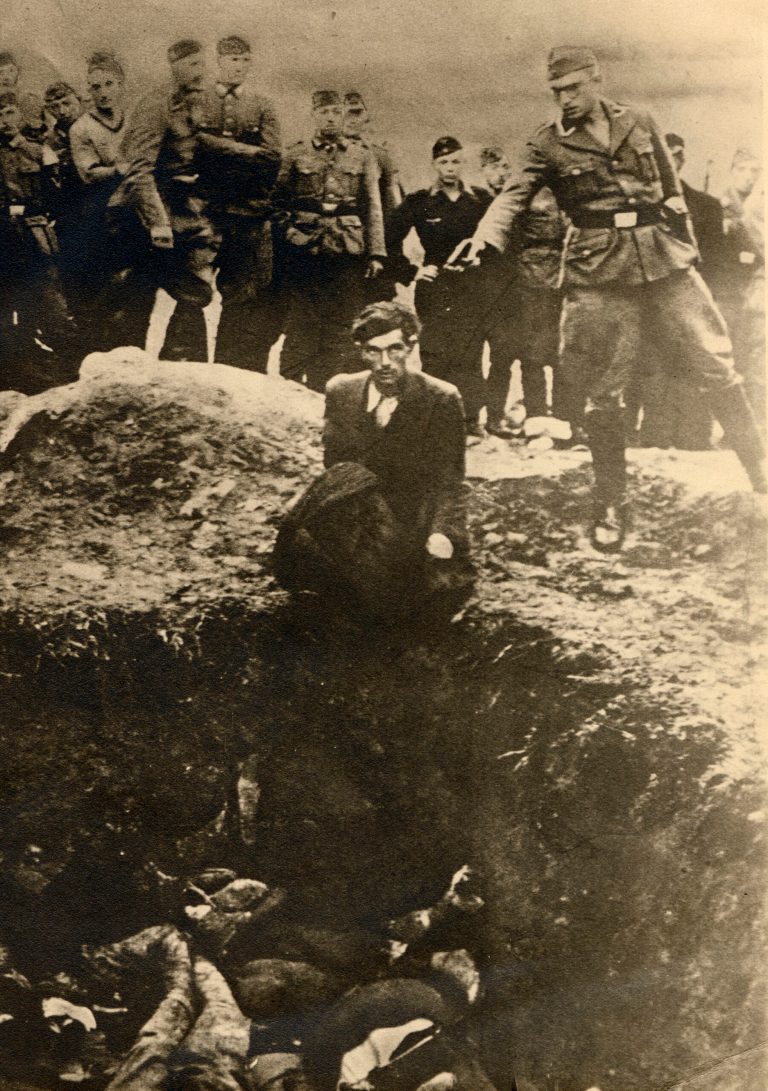 EDITORS  NOTES  GRAPHIC CONTENT - The photo taken between 1941 and 1943 near Vinnitsa, Ukraine, provided by the U.S. Holocaust Memorial Museum  shows German soldiers of the Waffen-SS and the Reich Labor Service looking on as a member of an Einsatzgruppe prepares to shoot a Ukrainian Jew kneeling on the edge of a mass grave filled with corpses. The Simon Wiesenthal Center has identified dozens of former members of Nazi mobile death squads who might still be alive, and is pushing the German government for an investigation, The Associated Press has learned on Wednesday, Oct. 1, 2014. The Wiesenthal Center's top Nazi hunter, Efraim Zuroff, told the AP that in September he sent the German justice and interior ministries a list of 76 men and four women who served in the so-called Einsatzgruppen.  (AP Photo/U.S. Holocaust Memorial Museum, courtesy of Sharon Paquette) NO ARCHIVE