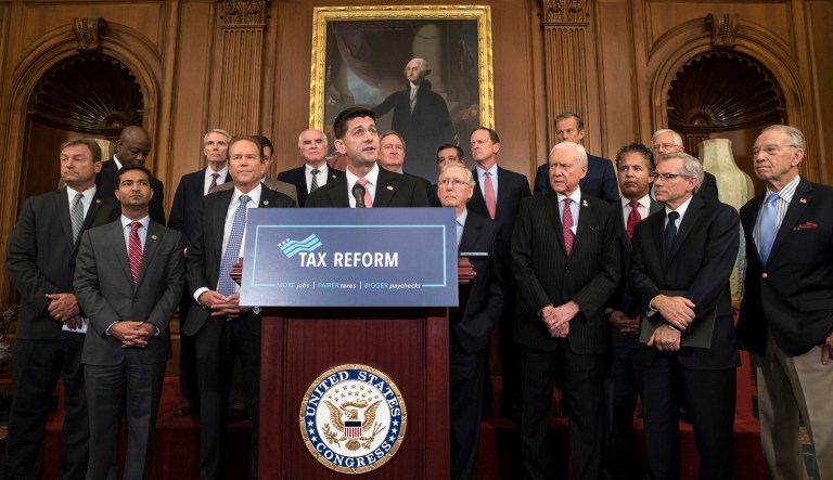 FILE - In this Wednesday, Sept. 27, 2017, file photo, Speaker of the House Paul Ryan, R-Wis., at podium, speaks about the Republicans' proposed rewrite of the tax code for individuals and corporations, at the Capitol in Washington. President Donald Trump and congressional Republicans are writing a far-reaching, $5.8 trillion plan they say would simplify the tax system and nearly double the standard deduction used by most Americans. (AP Photo/J. Scott Applewhite, File)