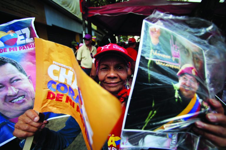 A supporter of Venezuela's President Hugo Chavez celebrates his return at Bolivar Square in Caracas, Venezuela, Monday, Feb. 18, 2013. Chavez returned to Venezuela early Monday after more than two months of treatment in Cuba following cancer surgery, his government said, triggering street celebrations by supporters who welcomed him home while he remained out of sight at the Carlos Arvelo Military Hospital in Caracas, where he will continue his treatment. (AP Photo/Fernando Llano)