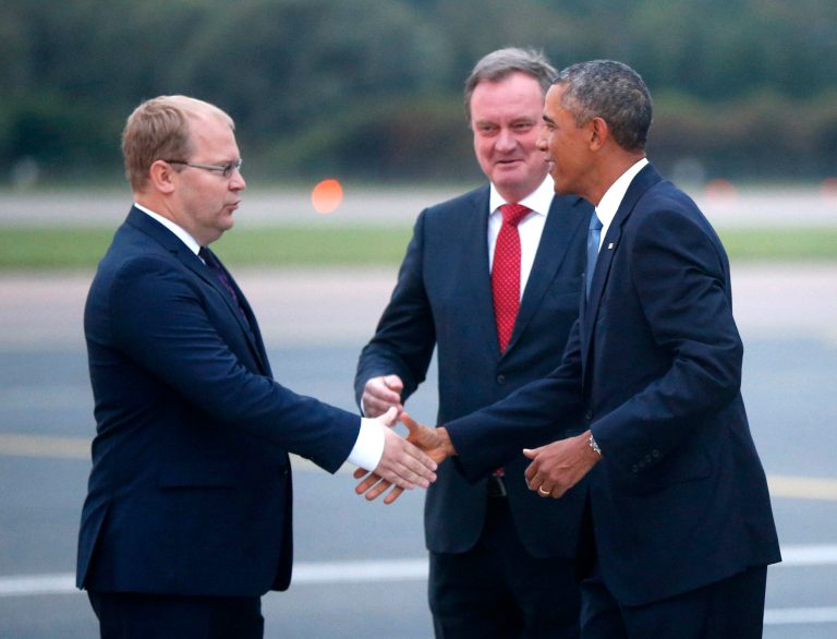 U.S. President Barack Obama is greeted by Estonia's Minister of Foreign Affairs Urmas Paet, left, and Estonia's Chief of Protocol Toomas Kahur, center, as he arrives in Tallinn, Estonia, Wednesday, Sept. 3, 2014, for a one day visit where he will meet with Baltic State leaders before heading to the NATO Summit in Wales. (AP Photo/Charles Dharapak)