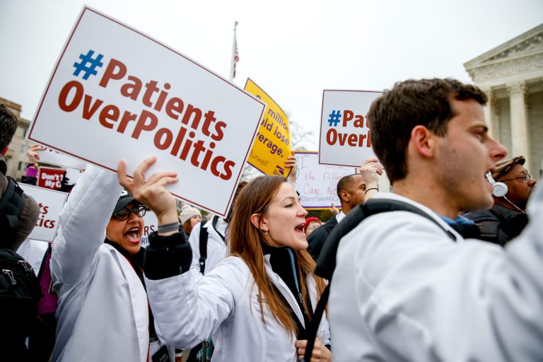 University of Maryland medical student Sarah Britz, center, and others, rally outside the Supreme Court in Washington, Wednesday, March 4, 2015 in Washington, as the court was hearing arguments in King v. Burwell, a major test of President Barack Obama's health overhaul which, if successful, could halt health care premium subsidies in all the states where the federal government runs the insurance marketplaces. (AP Photo/Andrew Harnik)