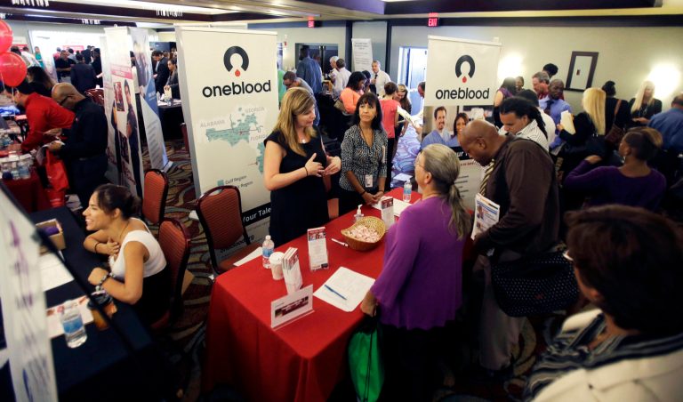   In this Wednesday, Aug. 14, 2013 photo, job seekers check out companies offering more than 2,000 job opportunities at a job fair in Miami Lakes, Fla. The number of people seeking U.S. unemployment benefits rose 13,000 the week of Aug. 12, to a seasonally adjusted 336,000, but the level remains consistent with solid job gains, according to information released by the Labor Department, Thursday, Aug. 22, 2013. (AP Photo/Alan Diaz)  