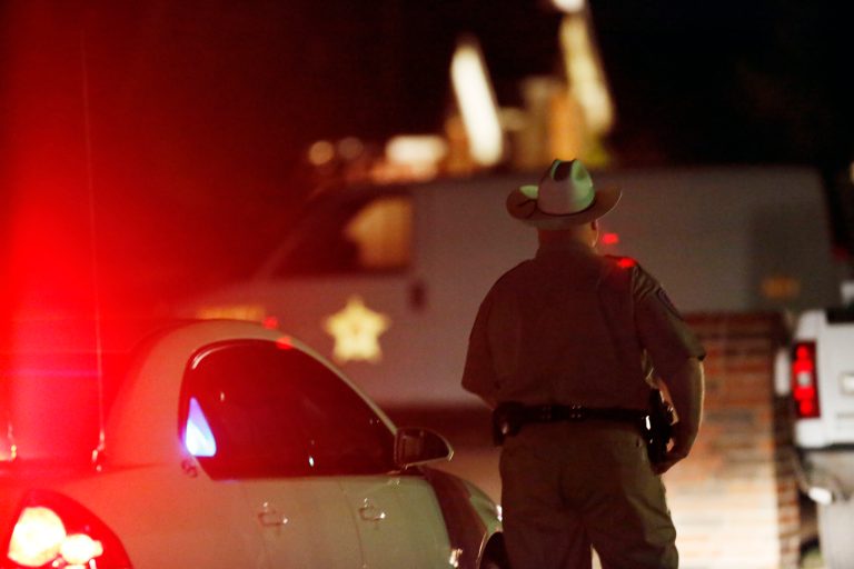 In this Saturday, March 30, 2013 photo, authorities block off Blarney Stone Road in Forney, Texas, where Kaufman County District Attorney Mike McLelland and wife Cynthia McLelland were found dead in their home near Forney, Texas. (AP Photo/The Dallas Morning News, Ian C. Bates) MANDATORY CREDIT; MAGS OUT; TV OUT; INTERNET USE BY AP MEMBERS ONLY; NO SALES