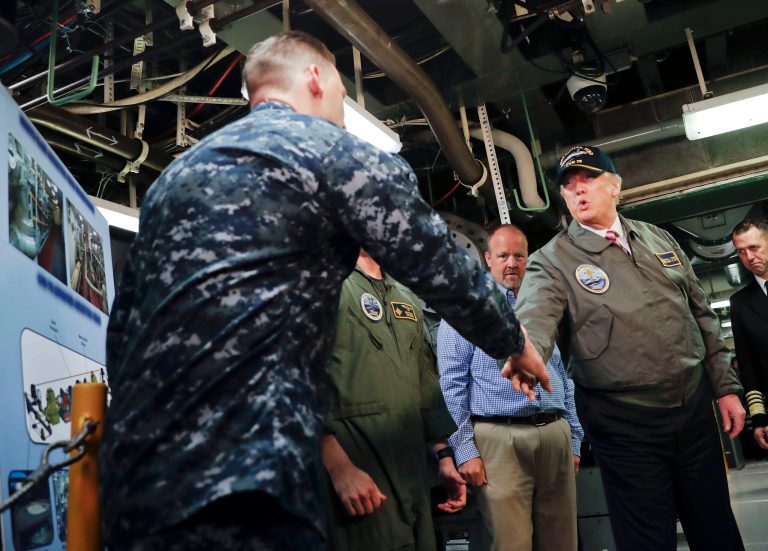President Trump shakes hands with Petty Office 1st Class John Thompson ABE1, during a tour of the nuclear aircraft carrier Gerald R. Ford, on March 2 at Newport News Shipbuilding in Newport, Va. Trump traveled to Virginia to meet with sailors and shipbuilders on aircraft carrier which is scheduled to be commissioned this year after cost overruns and delays. (AP Photo/Pablo Martinez Monsivais)