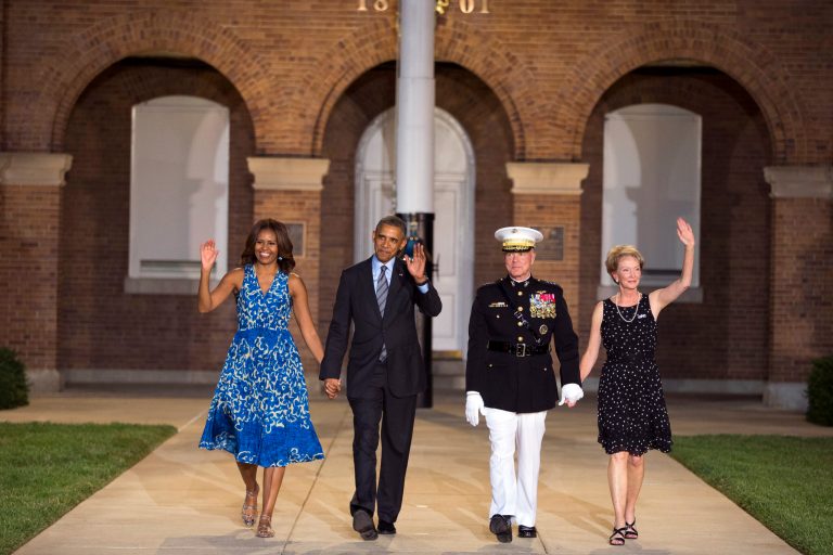President Barack Obama, second from left, and first lady Michelle Obama, left, are escorted to their seats by Marine Commandant Gen. James Amos, second from right, and his wife Bonnie Amos during the Marine Barracks Evening Parade, Friday, June 27, 2014, in Washington. (AP Photo/ Evan Vucci)