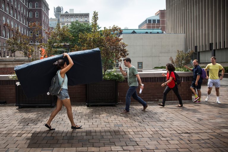 Emma Sulkowicz, a senior visual arts student at Columbia University, carries a mattress in protest of the university's lack of action after she reported being raped during her sophomore year on September 5, 2014 in New York City. (Photo by Andrew Burton/Getty Images)