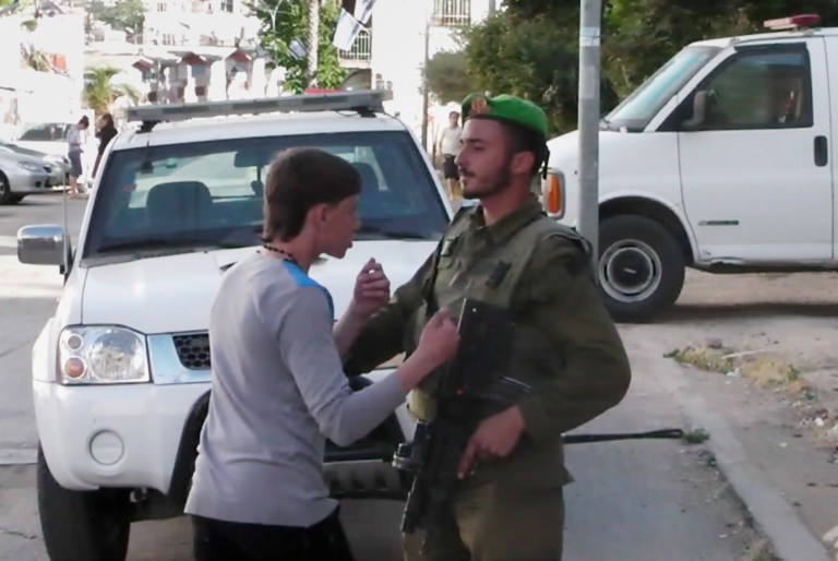 In this image taken from video obtained from Youth Against Settlements, a group of Palestinian activists, which has been authenticated based on its contents and other AP reporting, a Palestinian teen confronts an Israeli soldier in the West Bank city of Hebron. The reprimand of an Israeli soldier, caught on video cursing and pointing a cocked gun toward the head of a Palestinian teen, has triggered the biggest outpouring of frustration by Israeli soldiers in years about their service in the West Bank. (AP Photo/Youth Against Settlements)