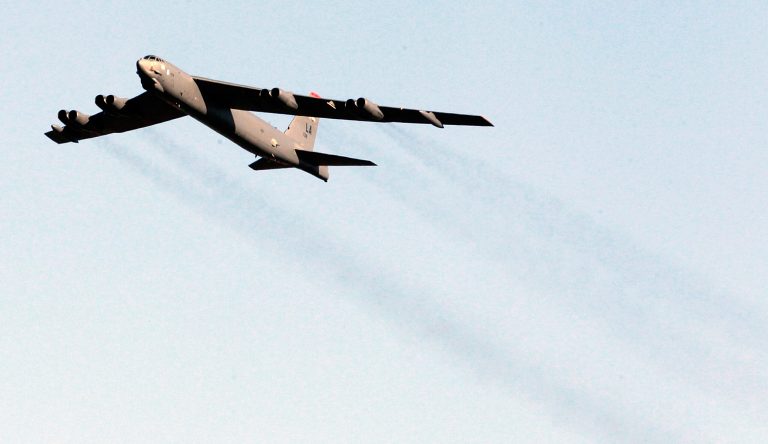 A B-52 bomber aircraft flyover is seen at Arlington National Cemetery, in Arlington, Va., on Feb. 11, 2011. (AP Photo/Manuel Balce Ceneta)