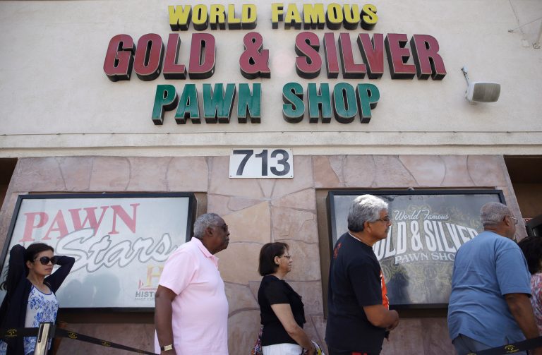 People wait in line to enter the Gold & Silver Pawn Shop in Las Vegas Monday, July 28, 2014, in Las Vegas. Rick Harrison, owner of the pawn shop and one of the stars of the reality television series Pawn Stars, has proposed building a shopping plaza on land nearby. (AP Photo/John Locher)