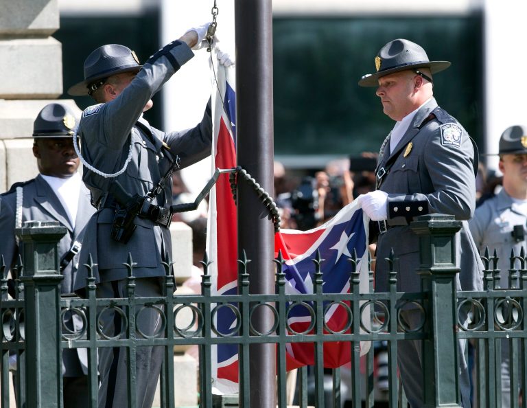 On July 10, 2015, an honor guard from the South Carolina Highway patrol lowered the Confederate battle flag as it is removed from the Capitol grounds in Columbia, S.C. (AP Photo/John Bazemore)