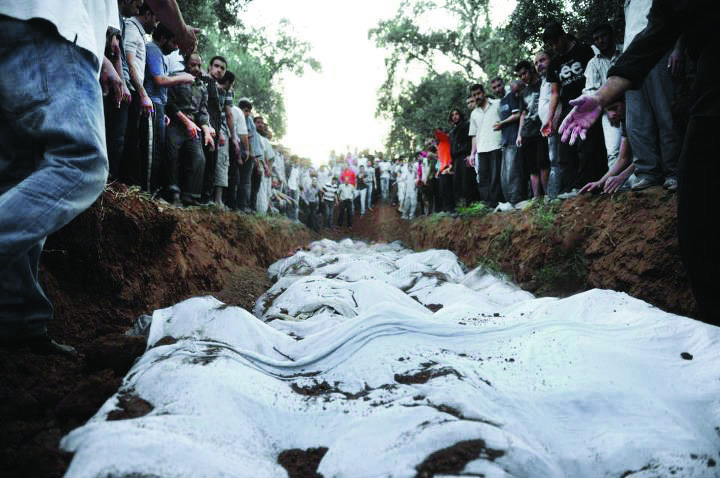 In this citizen journalism image provided by Shaam News Network SNN, taken on Wednesday, Aug. 1, 2012, Syrians pay their respect to those killed in Damascus, Syria. Syrian opposition activists say regime forces have swept through neighborhoods south of the capital Damascus in a deadly military operation that has inflicted casualties. (AP Photo/Shaam News Network, SNN)THE ASSOCIATED PRESS IS UNABLE TO INDEPENDENTLY VERIFY THE AUTHENTICITY, CONTENT, LOCATION OR DATE OF THIS CITIZEN JOURNALIST IMAGE