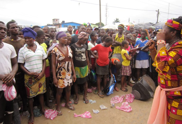 In this photo taken on July 8, 2014, Ebola advocacy group Crusaders for Peace, spokesperson Juli Endee, right, educates people on the deadly virus in Paynesville, east of the city  Monrovia, Liberia. Ebola, a hemorrhagic fever that can cause its victims to bleed from the ears and nose, had never before been seen in this part of West Africa where medical clinics are few and far between. The disease has turned up in at least two other countries _ Liberia and Sierra Leone _ and 539 deaths have been attributed to the outbreak that is now the largest on record. (AP Photo/Jonathan Paye-Layleh)