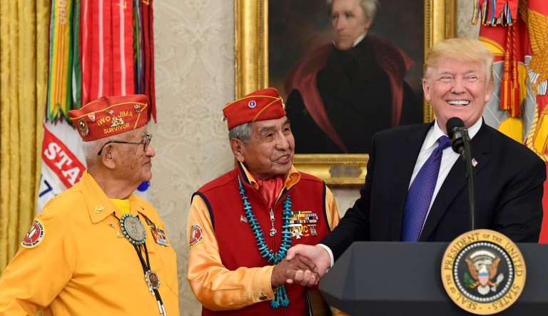 President Donald Trump, right, meets with Navajo code talkers Peter MacDonald, center, and Thomas Begay, left, in the Oval Office of the White House in Washington, Monday, Nov. 27, 2017. (AP Photo/Susan Walsh)