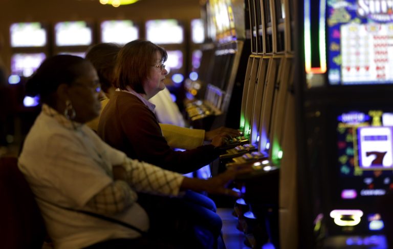 FILE--In this Nov. 6, 2013 file photo, people gamble at the Monticello Casino and Raceway in Monticello, N.Y.  A handful of existing gambling operations in New York are bidding for new upstate casinos amid fears of a crowding market. New York officials could soon begin granting up to four upstate New York casino licenses in a state that is already home to five tribal casinos and nine 