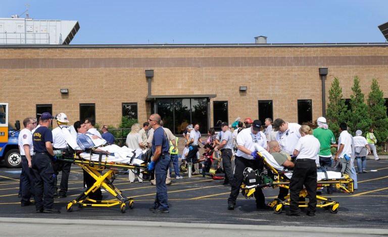   File - In a June 27, 2011 file photo, employees at the Tyson food processing plant in Springdale Ark., are helped by emergency personnel after being exposed to chlorine gas. The chlorine gas leak that sickened nearly 200 people happened because a worker who couldn't read the English-language label on a barrel of chemicals inadvertently poured bleach into it, the Centers for Disease Control and Prevention said in a report released Thursday.(AP Photo/The Morning News, Spencer Tirey, File)  
