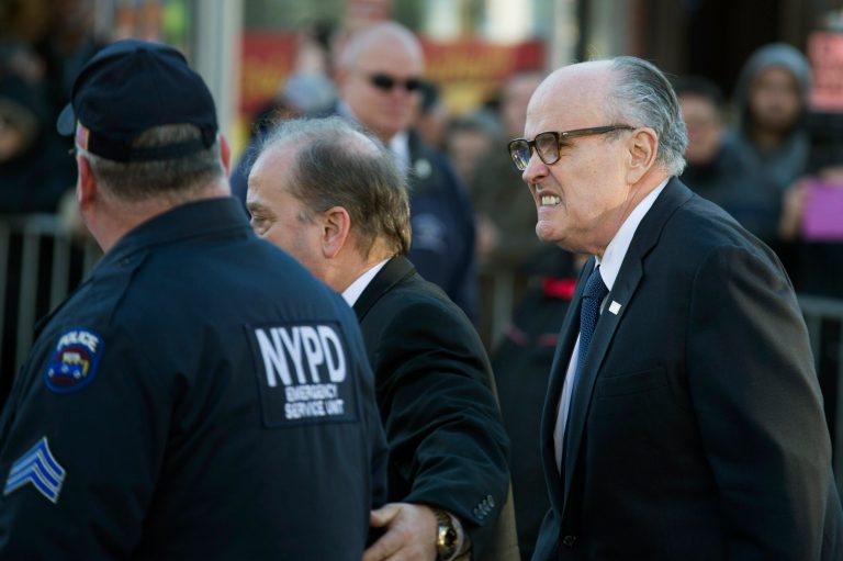 Former Mayor of New York City Rudy Giuliani arrives at the wake of officer Rafael Ramos at Christ Tabernacle Church, in the Glendale section of Queens, Friday, Dec. 26, 2014, in New York. (AP Photo/John Minchillo)