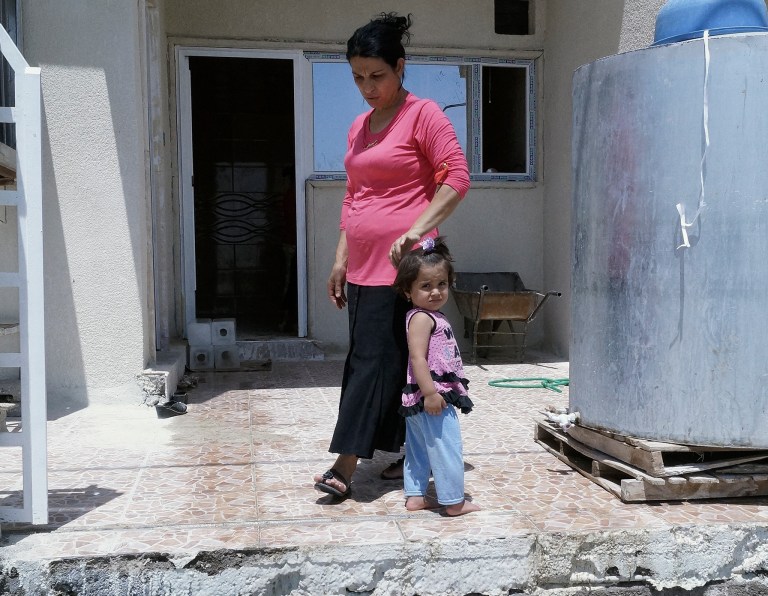 In this Sunday, July 20, 2014 photo, newly-arrived displaced Christians wait for relief aid at a church in the town of Hamadaniya, 25 miles (40 kilometers) north of Mosul, Iraq. Iraqi Christians have been fleeing from the northern city of Mosul in the wake of threats from Islamic State militants who took the city in a blitz offensive last month. The militants imposed a deadline Saturday for Christians to convert to Islam, pay a tax or face death.  (AP Photo)