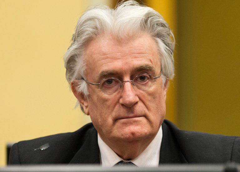 FILE - A Thursday, July 11, 2013 photo from files showing former Bosnian Serb leader Radovan Karadzic awaiting the start of his appeal at the courtroom of the U.N. Yugoslav war crimes tribunal (ICTY) in The Hague, Netherlands. Prosecutors called former Bosnian Serb political leader Radovan Karadzic a liar in closing remarks at his genocide trial, saying his denials of responsibility for atrocities committed on a massive scale while he was in charge lack any credibility. Prosecutor Alan Tieger said Karadzic, 69, should be imprisoned for life if found guilty. Karadzic says he is innocent of any wrongdoing and was unaware of the 1995 slaughter of more than 7,000 Muslim men and boys by Serb forces at Srebrenica, the worst massacre in Europe since World War II. (AP Photo/Michael Kooren, Pool, File)