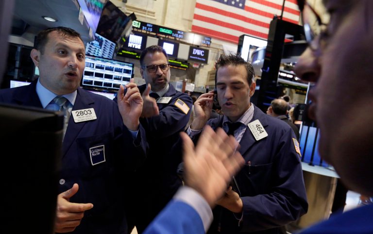 Specialists Vincent Surace, left, and Michael Urizzo, second left, and traders Gregory Rowe, third left, and Peter Costa work on the floor of the New York Stock Exchange Wednesday, July 9, 2014.  Stocks inched higher in early trading Wednesday, reversing a two-day decline, as the quarterly earnings season got underway with some positive news from the giant aluminum company Alcoa. (AP Photo/Richard Drew)