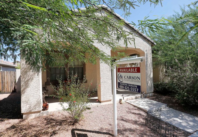 FILE - In  this Tuesday, July 30, 2013, file photo, a realty sign hangs in front of a home for sale in Gilbert, Ariz. Freddie Mac reports on changes in average fixed mortgage rates for the last week of November on Thursday, Dec. 5, 2013.  (AP Photo/Matt York, File)