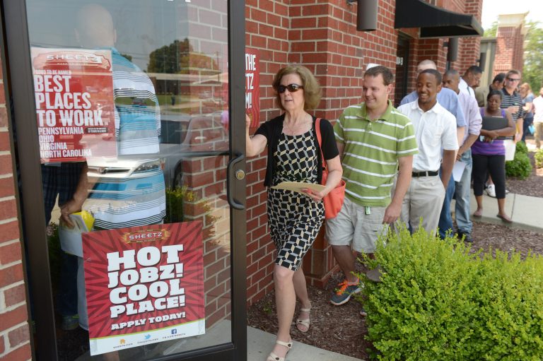 In this Wednesday, June 18, 2014 photo, job seekers attend a job fair held by Sheetz to staff their under-construction distribution center, in Burlington, N.C.  The Labor Department reports the number of people who applied for unemployment benefits last week on Thursday, June 19, 2014. (AP Photo/The Times-News, Sam Roberts)