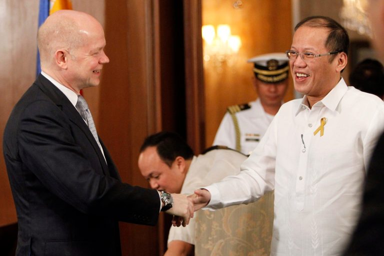 Philippines President Benigno Aquino III, right, greets British Foreign Secretary William Hague during his visit to the presidential palace in Manila, Philippines Thursday, Jan. 30, 2014. (AP Photo/Romeo Ranoco, Pool)