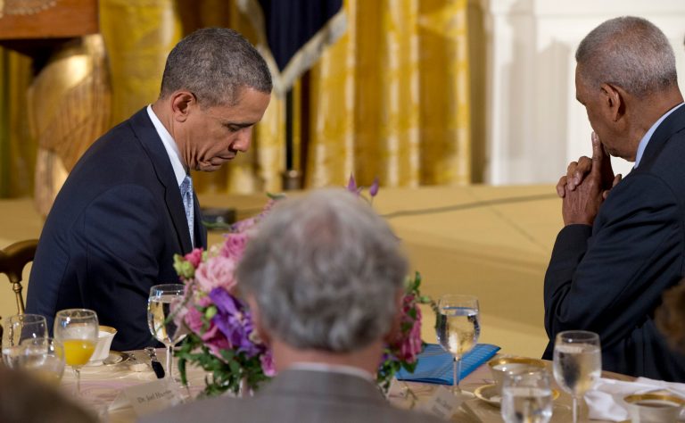President Barack Obama closes his eyes as Dr. Joel C. Hunter, senior pastor of Northland, A Church Distributed, in Longwood, Fla., says the prayer during the Easter Prayer Breakfast, Monday, April 14, 2014, in the East Room of the White House in Washington. (AP Photo/Carolyn Kaster)