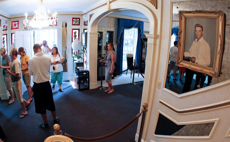   FILE -- This Aug. 2010 photo shows tourists arriving through the front door of Graceland, Elvis Presley's home in Memphis, Tenn. Graceland opened for tours on June 7, 1982. They sold out all 3,024 tickets on the first day and didn't look back, forever changing the Memphis tourist landscape while keeping Elvis and his legend alive.(AP Photo/Mark Humphrey)  