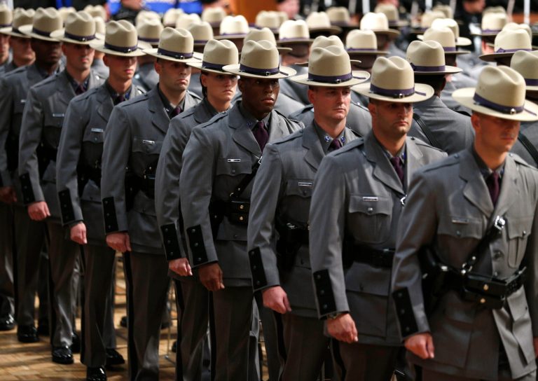 Some of the nearly 170 graduating troopers march into the Empire State Plaza Convention Center during the New York State Police 201st Session graduation ceremony on Thursday, July 17, 2014, in Albany, N.Y. (AP Photo/Mike Groll)
