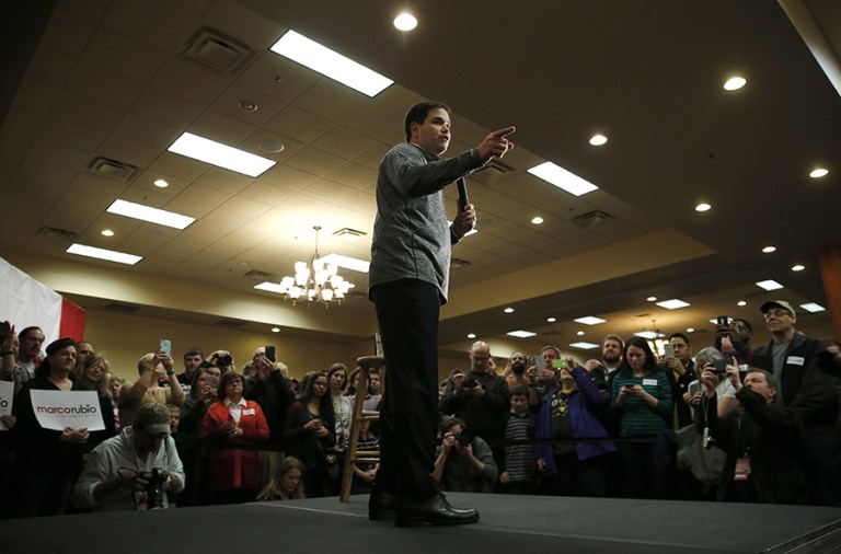 In subtle ways, even Rubio has to adapt his message to Trump and the climate of anger that has made the billionaire the prohibitive front-runner in Iowa and beyond, particularly on immigration. (AP photo/Kiichiro Sato)