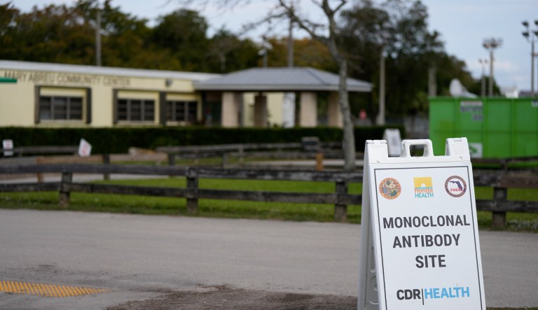 A sign directs the public to a site that had been administering monoclonal antibody treatments for COVID-19 until closing in compliance with federal regulations, Tuesday, Jan. 25, 2022, in Miami. Senate HELP Committee members are pressing the Biden administration about a canceled contract with KPMG that was meant to expand access to the treatments. (AP Photo/Rebecca Blackwell)