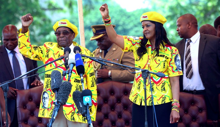 Zimbabwe's President Robert Mugabe and his wife Grace chant the party's slogan during a solidarity rally in Harare. Zimbabwe's president said he fired his deputy and longtime ally for scheming to take power, including by consulting witch doctors. Now Mugabe's wife appears poised for the role. (AP Photo)