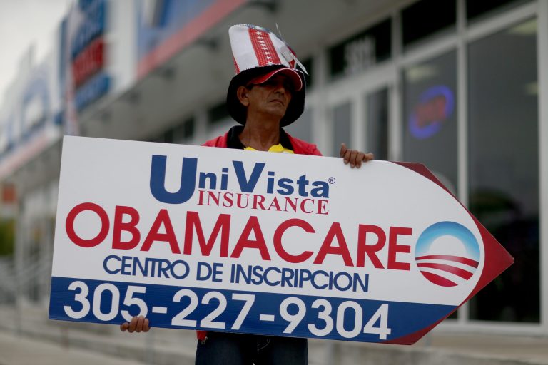 Oreste Alvarez holds a sign directing people to UniVista Insurance company where they can sign up for the Affordable Care Act on February 5, 2015 in Miami. (Photo by Joe Raedle/Getty Images)