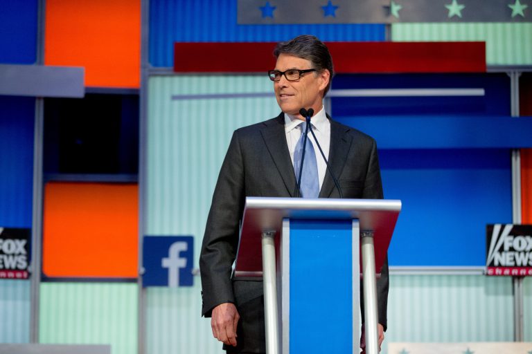 Republican presidential candidate former Texas Gov. Rick Perry stands on stage for a pre-debate forum at the Quicken Loans Arena, Thursday, Aug. 6, 2015, in Cleveland. Seven of the candidates have not qualified for the primetime debate. (AP Photo/Andrew Harnik)