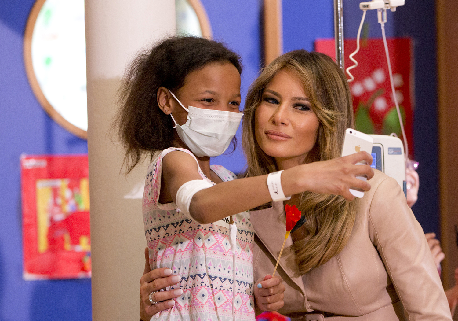 First lady Melania Trump takes selfies with children at Brussels hospital