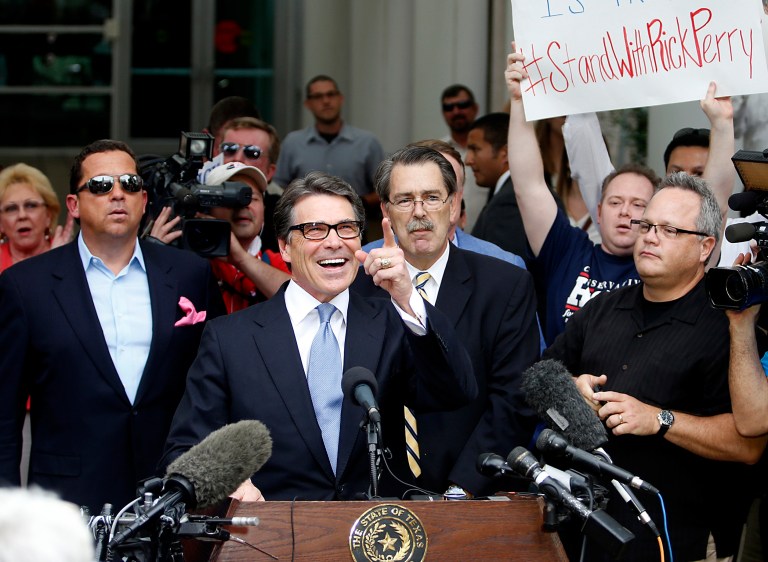 Texas Governor Rick Perry acknowledges supporters as he steps to the podium to speak to the press before turning himself in to authorities. Perry was indicted last Friday on felony charges of abuse of power and coercion of a public servant. (Getty images / Stewart F. House)