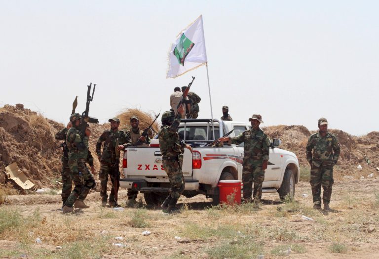 Iraqi security forces and Shiite militiamen chant anti-terrorism slogans after breaking the siege on the farming community town of Amirli, following U.S. airstrikes against the Islamic State. (AP Photo)