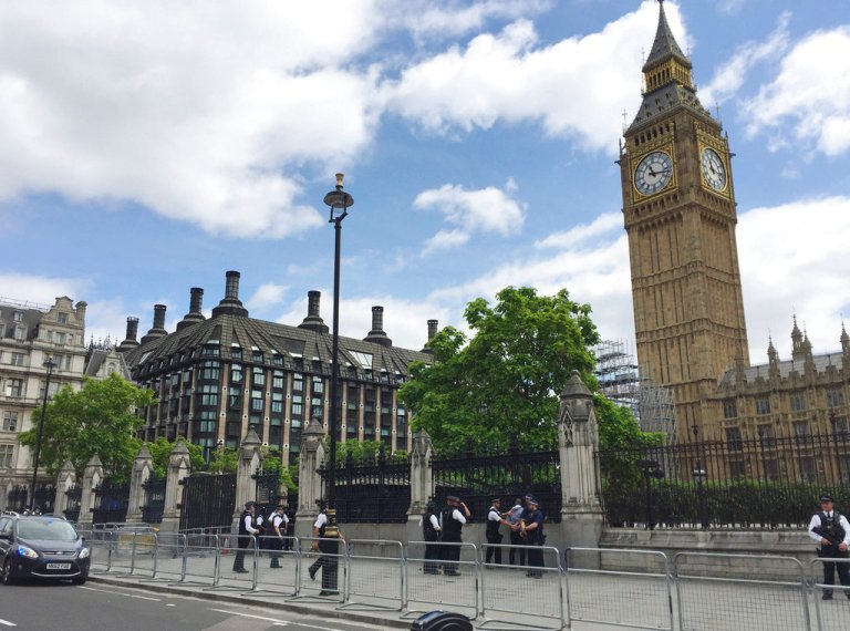 Police detain a man outside the House of Commons, London, Friday June 16, 2017. Scotland Yard said the man - aged in his 30s - was arrested on suspicion of possessing a knife. there were no injuries. Friday's incident comes just months after a man barreled his car into pedestrians on nearby Westminster Bridge and then charged into a Parliament courtyard, stabbing a police officer to death. In this case, security of the perimeter did not appear to be breached. (Harriet Line/PA via AP)