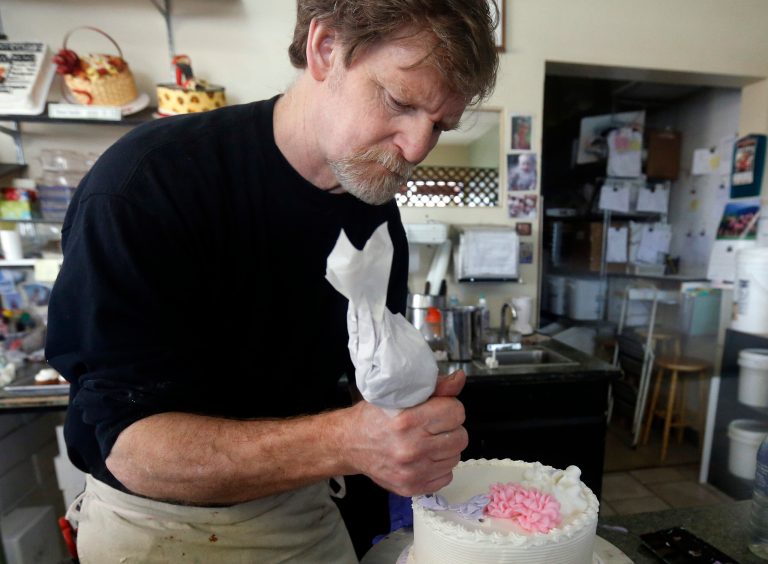 File - In this March 10, 2014 file photo, Masterpiece Cakeshop owner Jack Phillips decorates a cake inside his store, in Lakewood, Colo. Colorado's Civil Rights Commission on Friday upheld a judge's ruling that Phillips cannot refuse to make wedding cakes for same-sex couples, despite Phillips' cited religious opposition to same sex marriage. The panel says doing so violates state laws prohibiting businesses from discriminating against gay people. (AP Photo/Brennan Linsley, file)