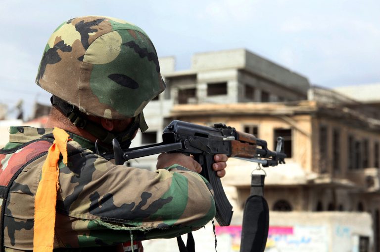 A Syrian army soldier takes his position at a street in Sabina suburb, south of Damascus, Syria, on Friday. (AP Photo/SANA)