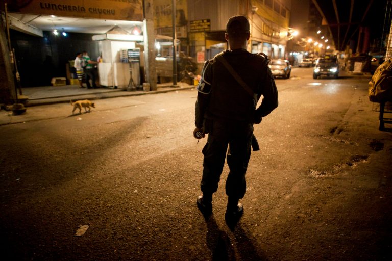 In this May 14, 2013 photo, a National Guard soldier stands guard on a street near a checkpoint that is part of the 