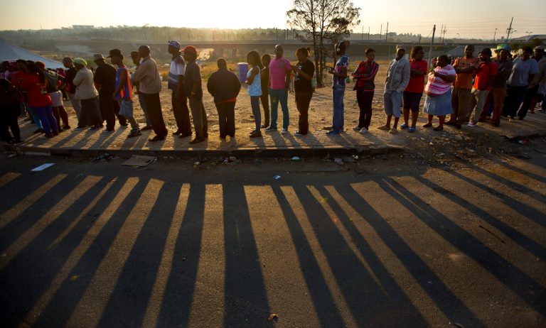 South Africans queue to cast their votes at sunset at a polling station in the Alexandra township of Johannesburg, South Africa Wednesday, May 7, 2014. South Africans voted Wednesday in elections that are expected to see the ruling African National Congress (ANC) return to power despite a vigorous challenge from opposition parties seeking to capitalize on discontent with corruption and economic inequality. (AP Photo/Ben Curtis)