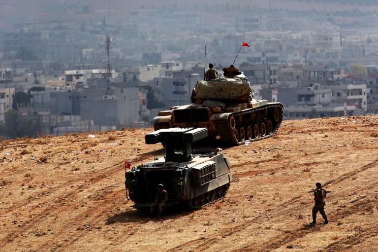 Turkish tank and armored vehicle soldiers hold their position at the Turkey-Syria border, overlooking Kobani, Syria on Thursday. (AP/Lefteris Pitarakis)