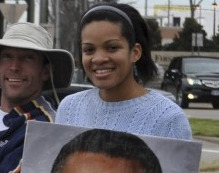 Kesha Rogers, a member of the left-wing Lyndon LaRouche movement, holds a sign showing President Obama with a Hitler-esque mustache. (Photo: Facebook)