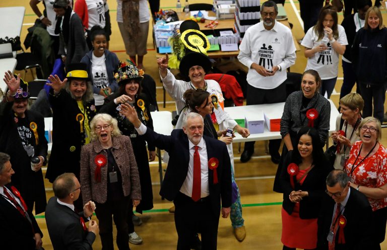 Britain's Labour party leader Jeremy Corbyn, bottom center, waves after arriving for the declaration at his constituency in London on June 9. Britain voted Thursday in an election that started out as an attempt by Prime Minister Theresa May to increase her party's majority in Parliament ahead of Brexit negotiations but was upended by terror attacks in Manchester and London during the campaign's closing days. (AP Photo/Frank Augstein)