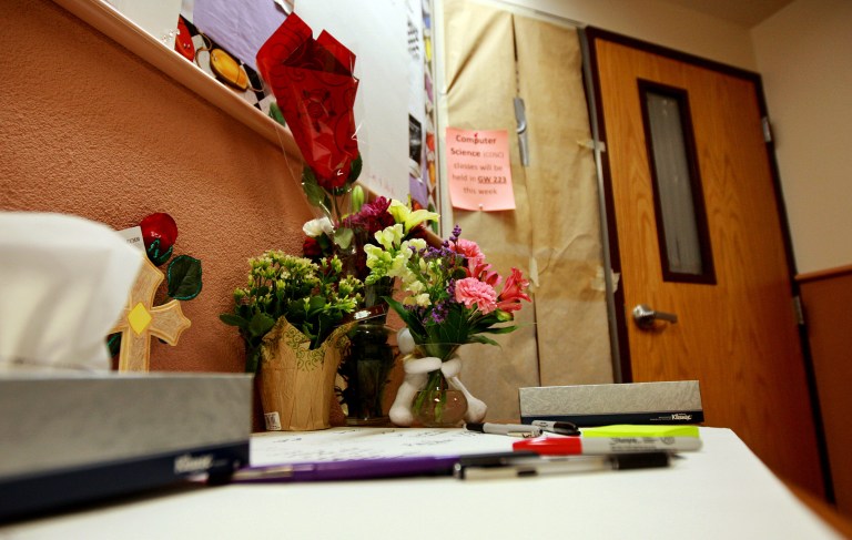   An impromptu memorial to Casper College instructors Jim Krumm and Heidi Arnold was set up Monday, Dec. 3, 2012 outside room 325 of the World Physical Science Center on the campus in Casper, Wyo. Chris Krumm, 25, killed Heidi Arnold outside the home she and Jim Krumm shared on Friday morning before killing his father and himself in the classroom. (AP Photo/Star-Tribune, Alan Rogers)  