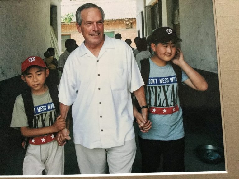 Former Commerce Secretary Don Evans with two Chinese boys he has mentored over 14 years, Li Hao, left, and Li Fan, right.