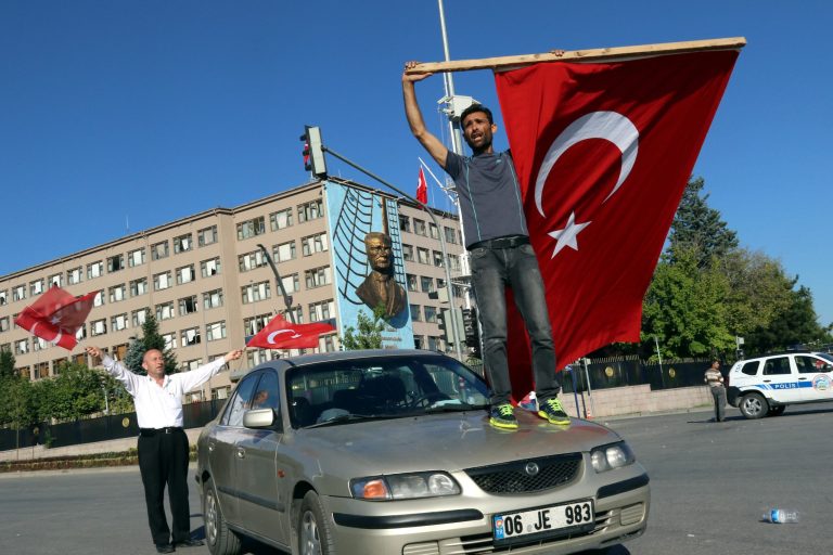 A man waves a Turkish flag as people protest Saturday in Ankara, Turkey against a coup. (AP Photo/Ali Unal)